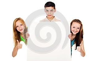 Young people holding a blank advertising poster