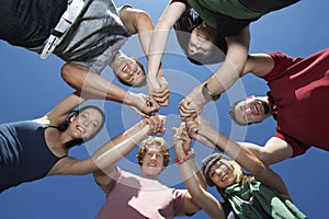 Young People Holding Hands In Circle