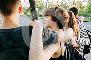 Young people hugging walking in the city