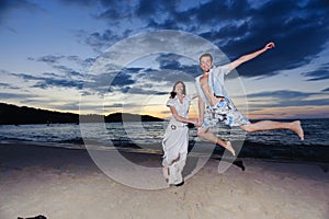 Young people jumping on the beach