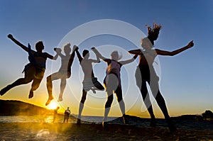 Young people jumping on the beach