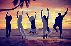 Young People Jumping with Excitement on the Beach