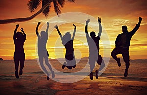 Young People Jumping with Excitement on the Beach photo