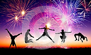 young people jumping on the hill with firework background