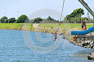 Young people jumping into Waioeka River enjoying summer fun