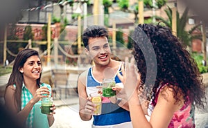 Young people laughing and drinking in summer party