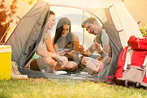 Young people laughing and joke while sitting in tent photo