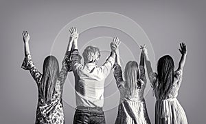 Young people leisure activity, all hands up. Group male, girls standing together holding hands, raise their hands up