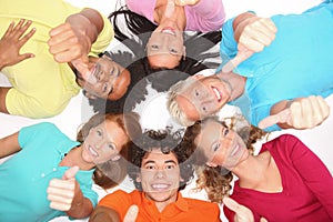 Young people lying down,gesturing thumb up sign