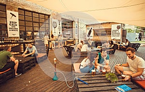 Young people meeting for drink in pop-up restaurant during outdoor Street Food Festival