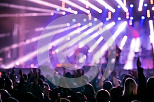 Young people at music festival or concert. Blurred background.