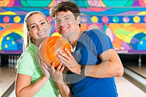 Young people playing bowling and having fun