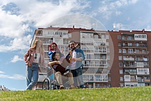 Young people playing guitar in the park