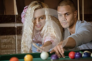 Young people playing snooker at bar