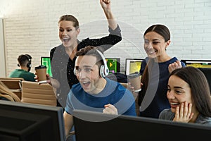 Young people playing video games on computers. Esports tournament