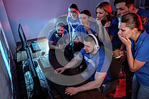 Young people playing video games on computers. Esports tournament photo