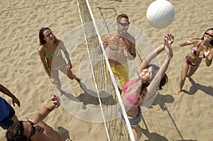 Young People Playing Volleyball On Beach