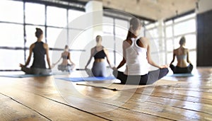 Young people practicing yoga in gym, focus on foreground