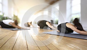 Young people practicing yoga in gym, focus on foreground