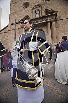 Young people in procession with incense burners in Holy week