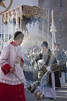 Young people in procession with incense burners in Holy week