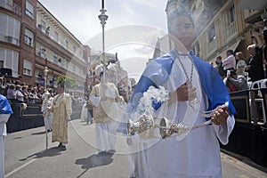 Young people in procession with incense burners