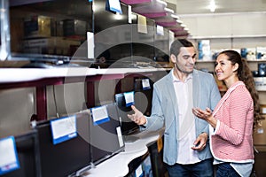 Young people purchasing television set