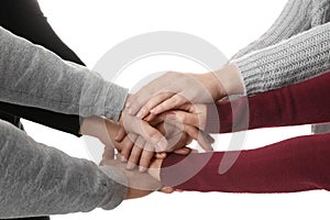 Young people putting their hands together on white, closeup