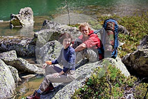 Young people are resting on trek in mountains