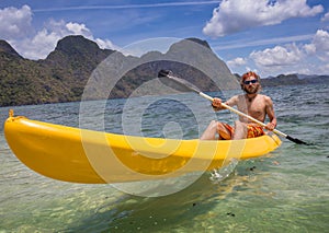 Young people rowing in kayak