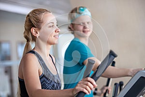 Young people on run simulators in gym