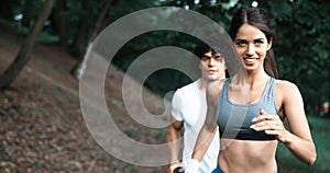 Young people running outdoors. Couple or friends of runners exercising in park