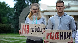 Young people showing slogans for world peace, against nuclear weapon, terrorism