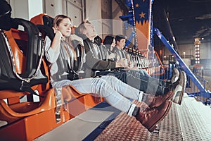 Young people are sitting on the attraction.