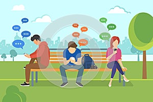 Young people sitting in the park and texting messages in chat using mobile smartphone