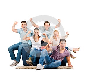 Young people sitting on a sofa cheering