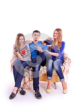 Young people sitting on a sofa and drinking soda