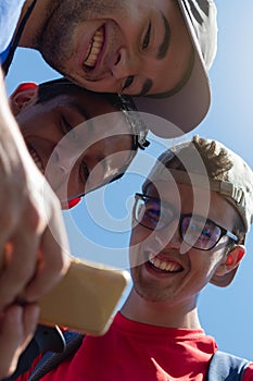 Young people smiling looking at photos and mobile social networks during a long walk on the Camino de Santiago in Spain