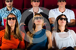 Young people strained watching 3d movie at movie theater