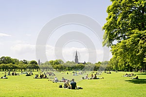 Young people, students of Edinburgh University enjoy a sunny day