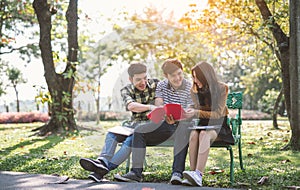 Young people studying reading book in park. education study by read.