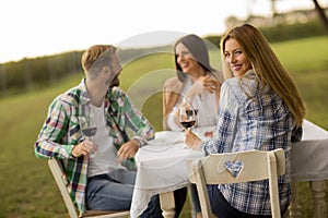 Young people by the table in the vineyard