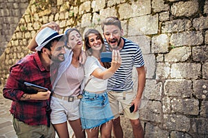 Young people taking selfies in city