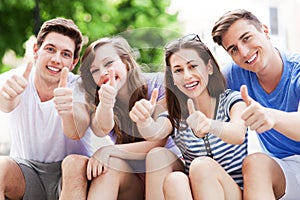 Young people with thumbs up