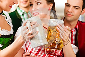 Young people in traditional Bavarian Tracht in restaurant or pub