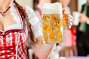 Young people in traditional Bavarian Tracht in restaurant or pub