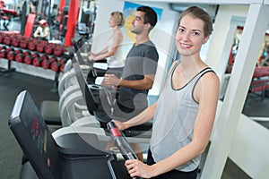 Young people training on exercise bikes in gym