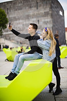 Young people using mobile phone on the bench in Vienna  Austria