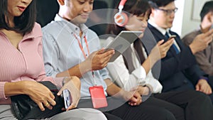 Young people using mobile phone in public underground train