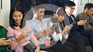 Young people using mobile phone in public underground train